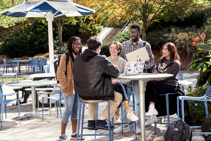 Phelps Scholars laughing and talking outside Lubbers Hall