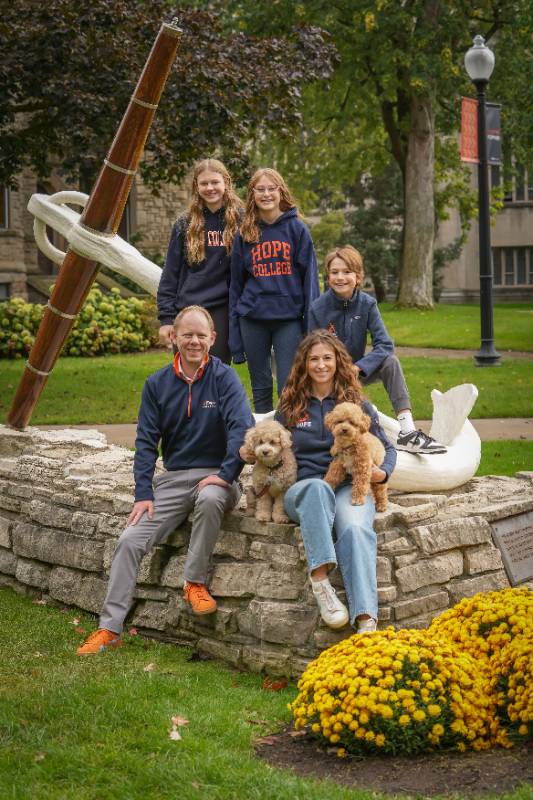 The Scogin Family standing around the anchor statue in Hope apparel