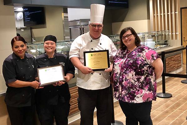 Pictured from left to right are members of the Creative Dining Services team directly involved in the 2019 NACUFS bronze and grand-prize awards received this spring and summer by Phelps Dining Hall’s GLOBE station.  From left to right are: Marycruz Ochoa, Angela Matusiak, Tom Hoover and Hailey Chrisman.
