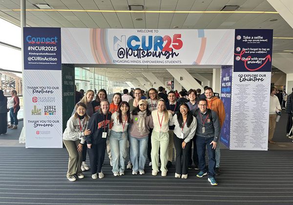 Students in front of the NCUR banner