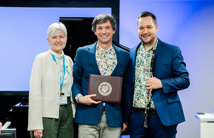 Music Teachers National Association (MTNA) awarded Hope professor Ben Krause (center) with the Thomas Ediger Distinguished Composer of the Year for his composition, Spaces Real or Imagined.  Presenting the award was Ann Rivers Witherspoon (at left) — chair of the MTNA commissioned composer program.  Clarinetist Gary June (right) accompanied Krause for their performance. Photo credit: Lan Vo Photograph
