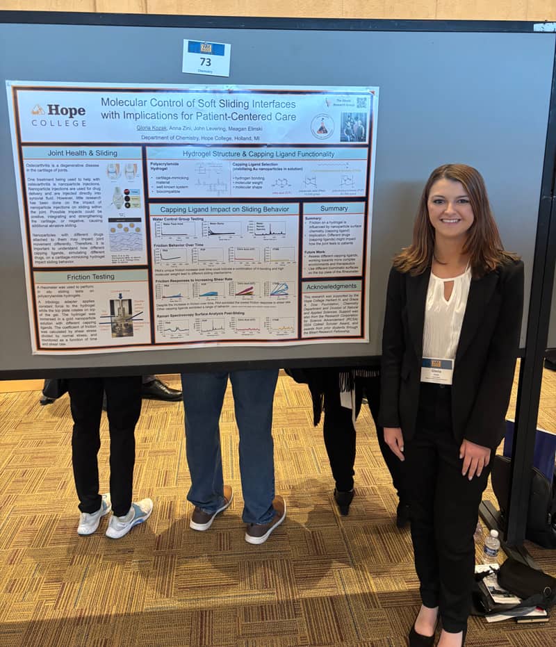 Gloria Kozak standing next to her research poster
