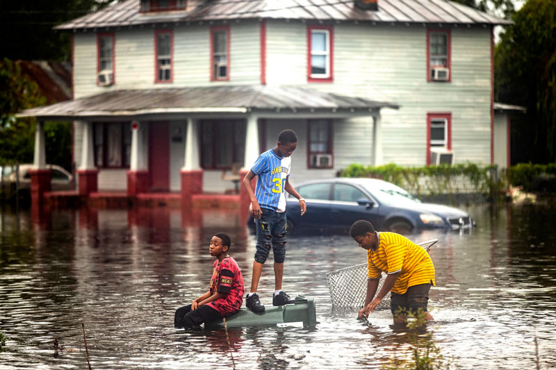 Three boys in floodwaters in New Bern, North Carolina