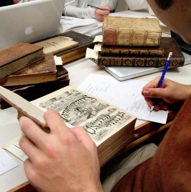 close up of student working on rare book