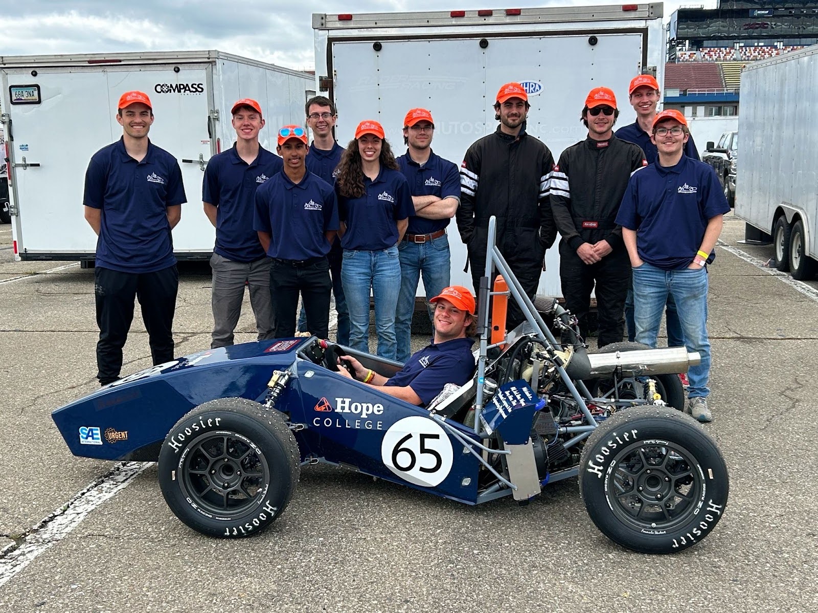 Members of the Hope College Formula Racing team pose with one of their cars at a 2018 competition.