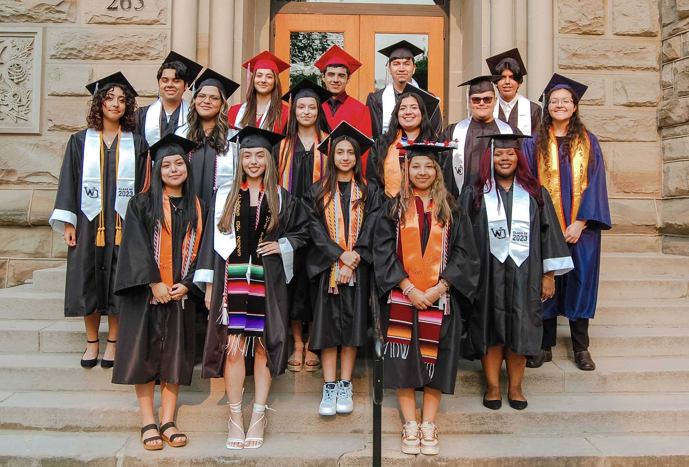 Upward Bound graduating class of 2023 in graduation robes and caps